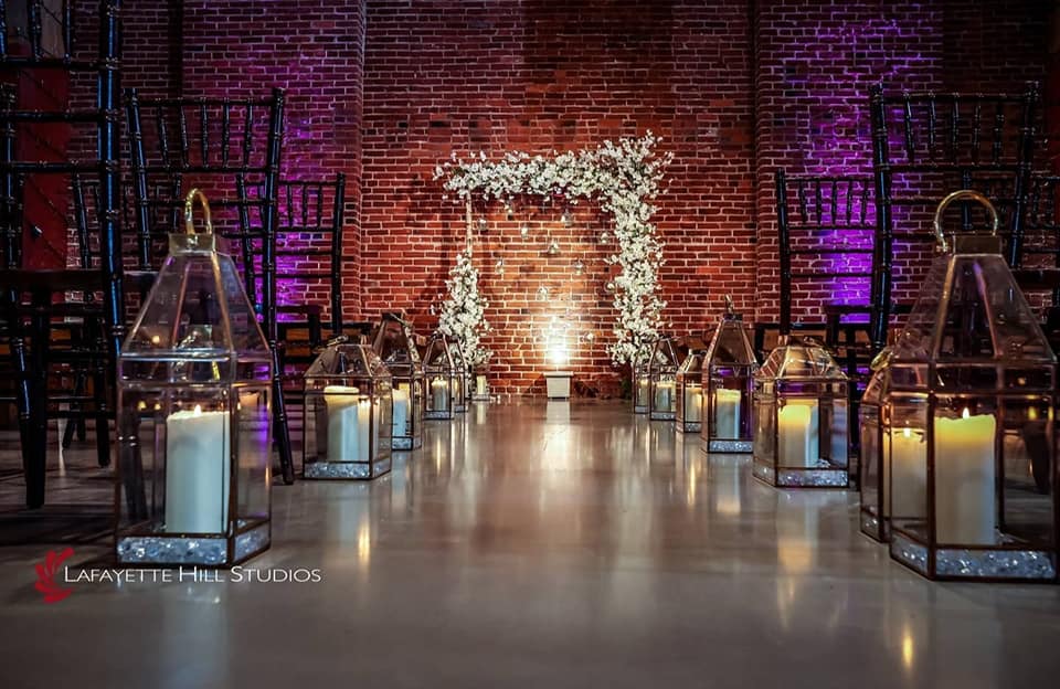 Wedding ceremony setup in the lobby at Billy Penn Studios with chairs, floral décor, and natural light flowing from the Glass Annex.
