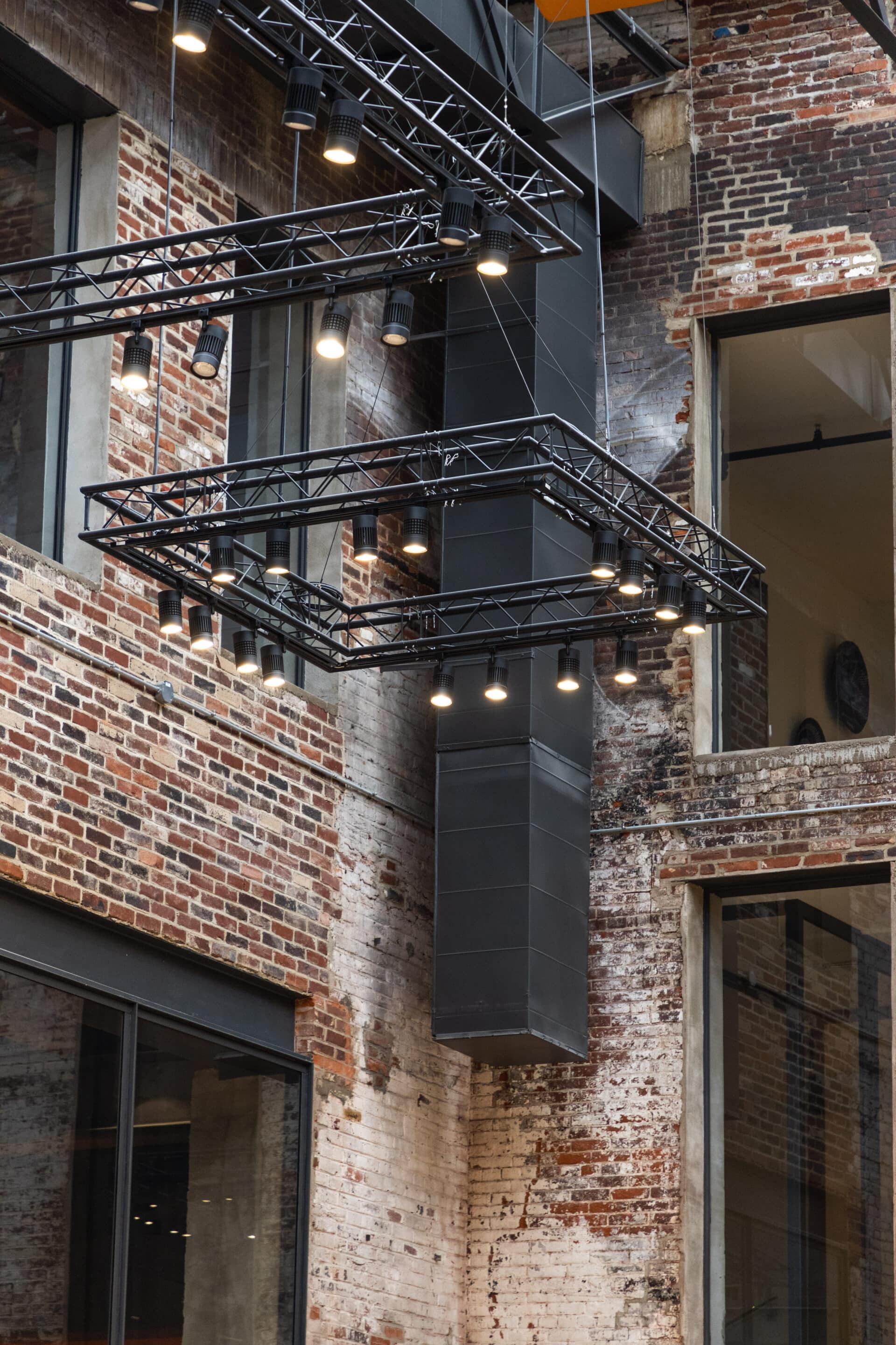Industrial Elegance in the Glass Annex Detail of exposed brick wall and steel studs inside the Glass Annex event space at Billy Penn Studios in Philadelphia.